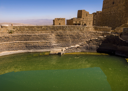 Traditional houses in front of a water cistern, Amran Governorate, Thula, Yemen