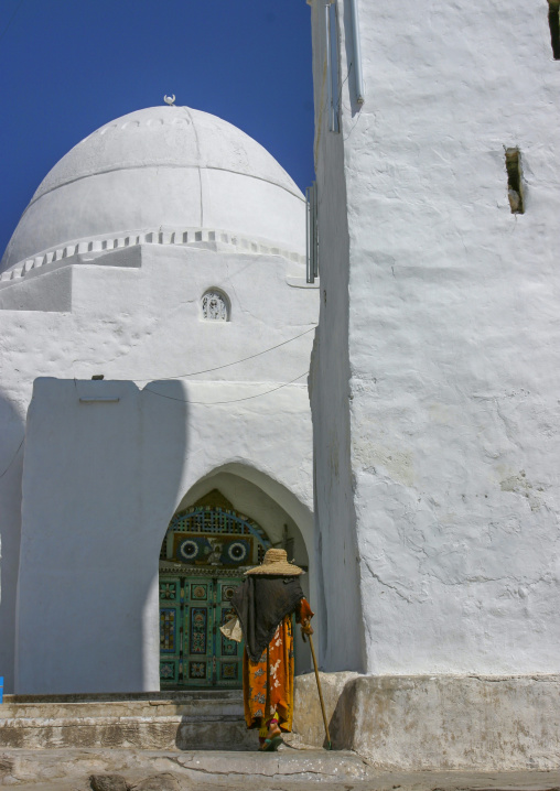 Yemeni woman going out of the white Mosque of Ahmed Ibn Alwan, Taiz Governorate, Yafrus, Yemen