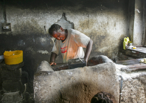 Cook making bbq in a restaurant, Al Hudaydah Governorate, Zabid, Yemen