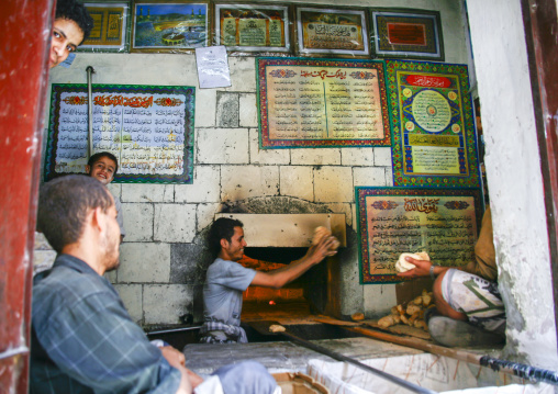 Baker working in front of his oven, Amanat Al-Asemah, Sanaa, Yemen