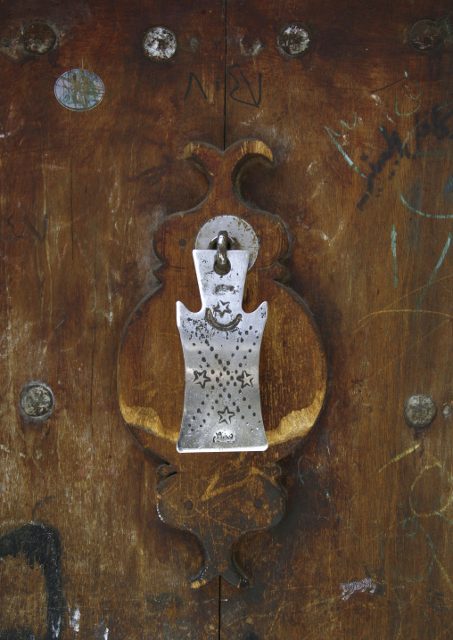 Ancient doorknocker on a wooden door, Amanat Al-Asemah, Sanaa, Yemen
