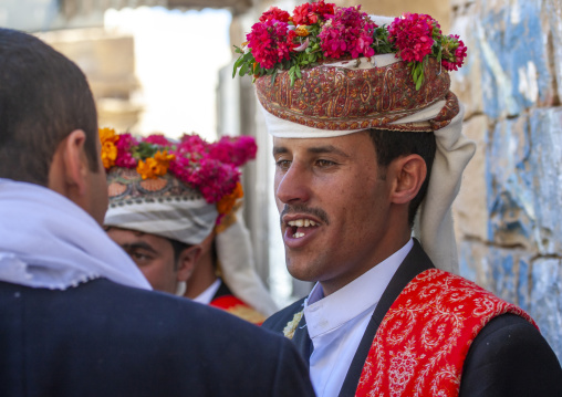 Grooms with turbans decorated with flowers during a wedding, Amran Governorate, Thula, Yemen