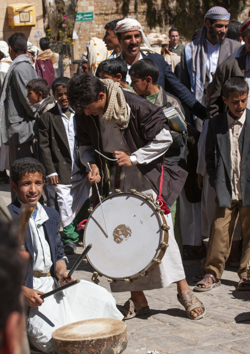 Yemeni man playing drum during a wedding, Amran Governorate, Thula, Yemen
