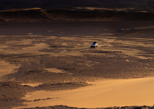 Car crossing the Sahara desert, Tassili N'Ajjer National Park, Tadrart Rouge, Algeria