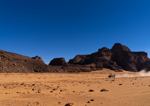 Four wheels in Rock formation in the desert, Tassili N'Ajjer National Park, Tadrart Rouge, Algeria