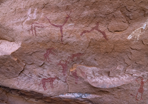 Rock painting depicting men hunting with dogs, Tassili N'Ajjer National Park, Tadrart Rouge, Algeria