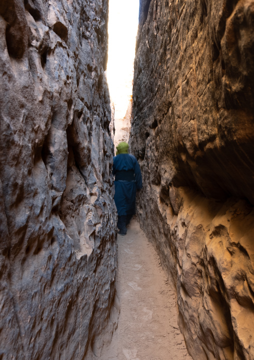 Tuareg in a narrow sandstone path, Tassili N'Ajjer National Park, Tadrart Rouge, Algeria