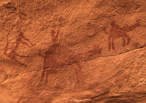 Rock painting depicting men riding camels, Tassili N'Ajjer National Park, Tadrart Rouge, Algeria