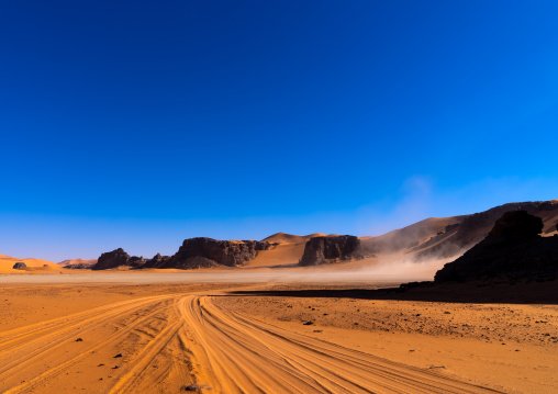 Car tire marks in the sand in Sahara desert, Tassili N'Ajjer National Park, Tadrart Rouge, Algeria