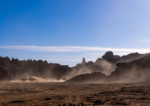 Rocks and sand dunes in windy Sahara desert, Tassili N'Ajjer National Park, Tadrart Rouge, Algeria