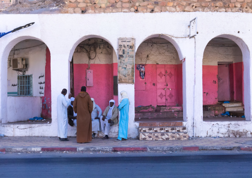 Tuareg men chatting under arcades in the city, North Africa, Djanet, Algeria