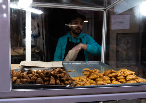 Algeria man selling pastries in El Ghezel souk, North Africa, Constantine, Algeria