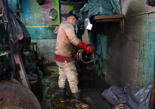 Algerian man working metal in a workshop in the Casbah, North Africa, Algiers, Algeria