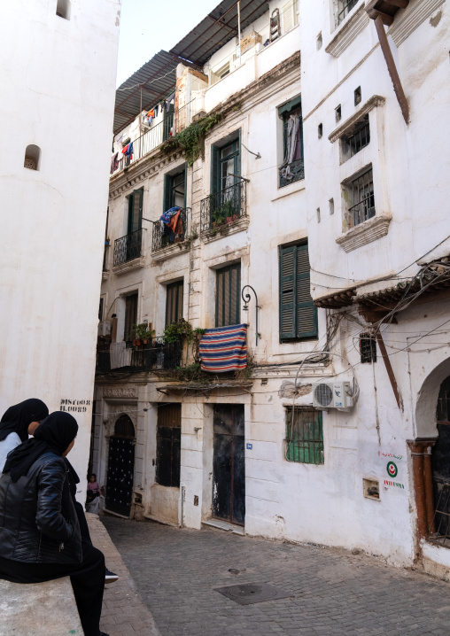 Algerian women sit in front an old building in the Casbah, North Africa, Algiers, Algeria