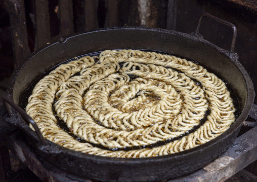 Jalebi sweets in cooking oil in Korail slum, Dhaka Division, Dhaka, Bangladesh