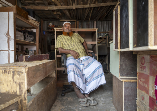 Bangladeshi carpenter sit in his shop, Dhaka Division, Dhaka, Bangladesh