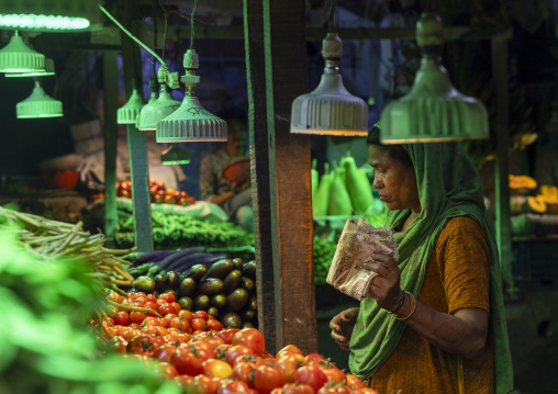 Woman buying vegetables at the morning market, Dhaka Division, Dhaka, Bangladesh