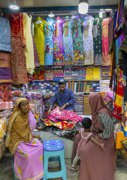 Bangladeshi man selling fabrics to women, Dhaka Division, Dhaka, Bangladesh