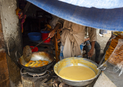 Bangladeshi man cooking fried food in the street, Dhaka Division, Dhaka, Bangladesh