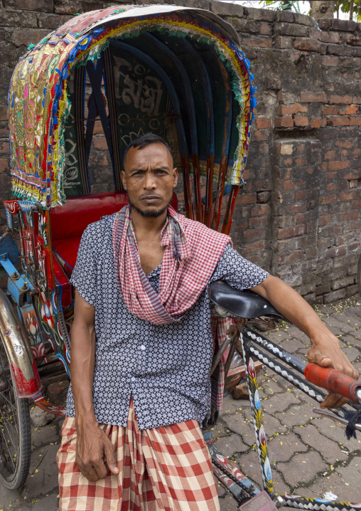 Portrait of a bangladeshi man with his rickshaw, Dhaka Division, Dhaka, Bangladesh