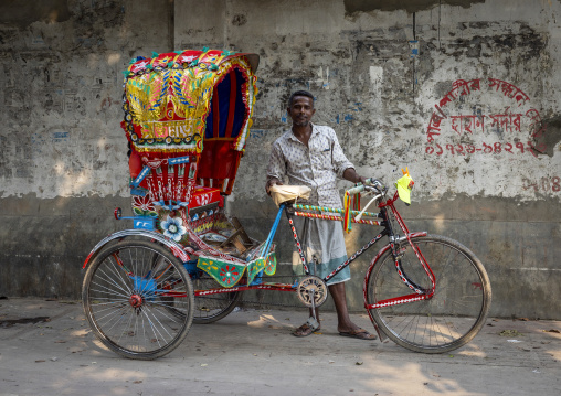 Portrait of a worker with his rickshaw, Dhaka Division, Dhaka, Bangladesh