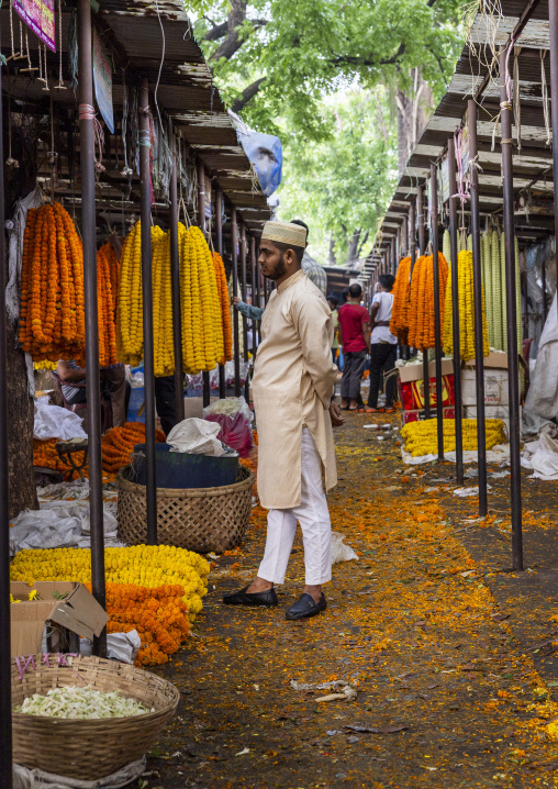 Bangladeshi man in flower market alley, Dhaka Division, Dhaka, Bangladesh