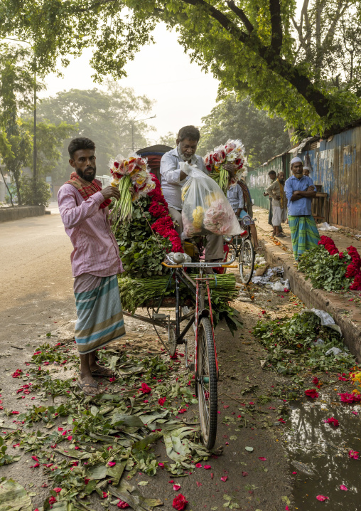 Bangladeshi men loading flowers on a rickshaw, Dhaka Division, Dhaka, Bangladesh