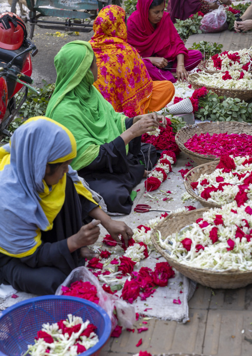 Women selling garlands of flowers at flower market, Dhaka Division, Dhaka, Bangladesh