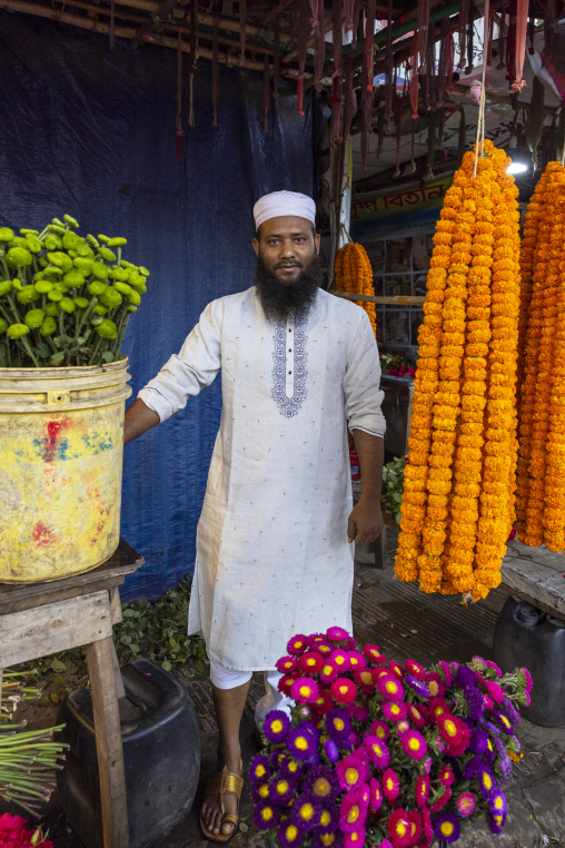 Bangladeshi man selling garland flowers at flower market, Dhaka Division, Dhaka, Bangladesh