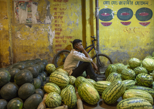 Bangladeshi man selling watermelons at Kawran Bazar market, Dhaka Division, Dhaka, Bangladesh