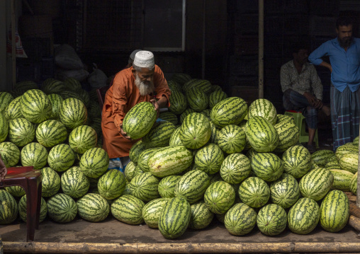 Bangladeshi man selling watermelons at Kawran Bazar market, Dhaka Division, Dhaka, Bangladesh