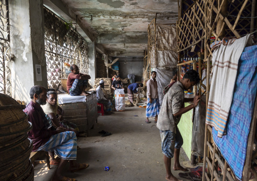 Bangladeshi men packing burlap sacks in Kawran bazar, Dhaka Division, Dhaka, Bangladesh