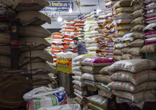 Bangladeshi man selling rice bags at Kawran bazar, Dhaka Division, Dhaka, Bangladesh