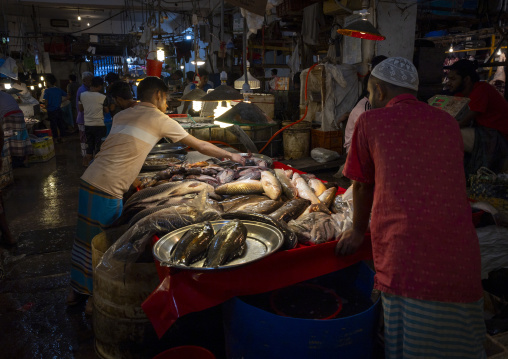 Bangladeshi man selling fresh fish at fish market, Dhaka Division, Dhaka, Bangladesh