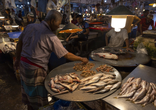 Bangladeshi man selling fresh fish at fish market, Dhaka Division, Dhaka, Bangladesh