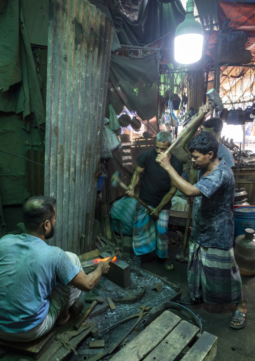 Bangladeshi blacksmiths working at Kawran bazar, Dhaka Division, Dhaka, Bangladesh