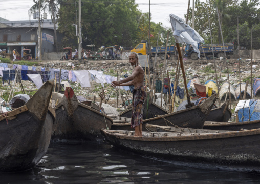 Bangladeshi man on a boat anchored on the bank of Buriganga River, Dhaka Division, Keraniganj, Bangladesh