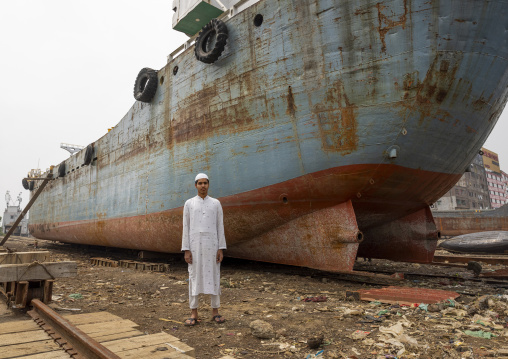 Bangladeshi man standing near a ship at Dhaka Shipyard, Dhaka Division, Keraniganj, Bangladesh