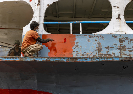 Painter painting ship at shipyard, Dhaka Division, Keraniganj, Bangladesh