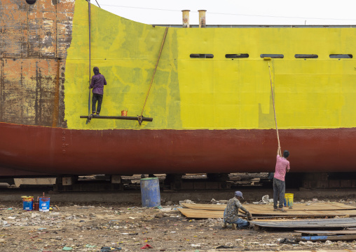 Painter painting ship at shipyard, Dhaka Division, Keraniganj, Bangladesh