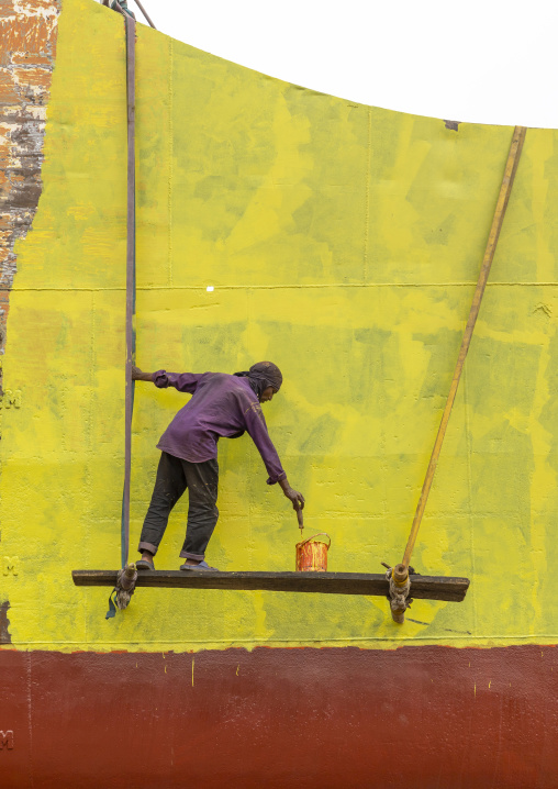 Painter painting ship at shipyard, Dhaka Division, Keraniganj, Bangladesh