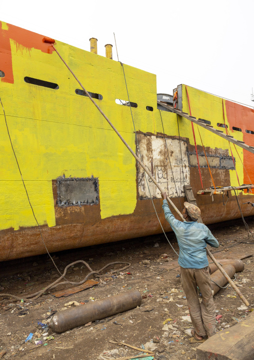 Painter painting ship at shipyard, Dhaka Division, Keraniganj, Bangladesh