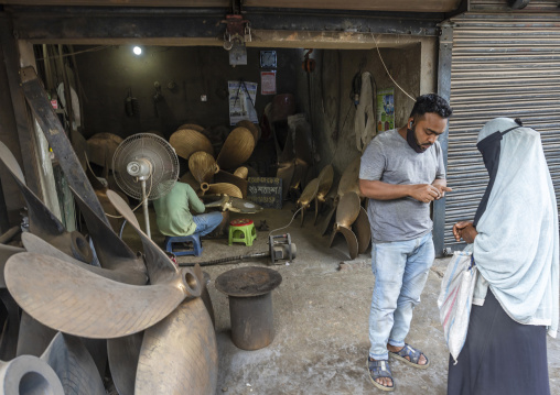 Woman in burqa in front of  a propeller workshop, Dhaka Division, Keraniganj, Bangladesh