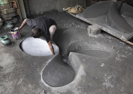 Dockyard worker making a mold for a propeller, Dhaka Division, Keraniganj, Bangladesh