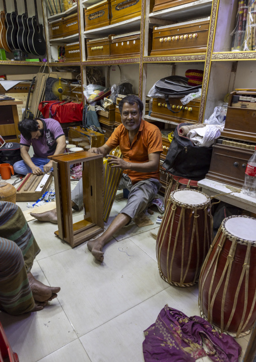 Bangladeshi man repairing a musical instrument, Dhaka Division, Dhaka, Bangladesh