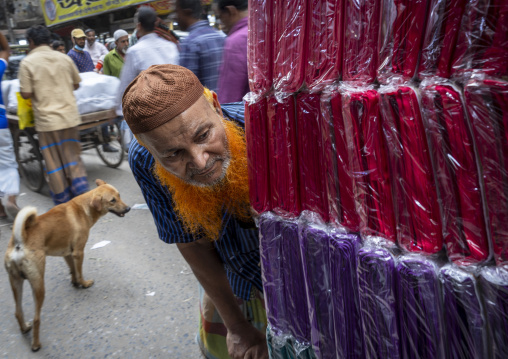 Bangladeshi man with a beard dyed in henna pushing a cart, Dhaka Division, Dhaka, Bangladesh