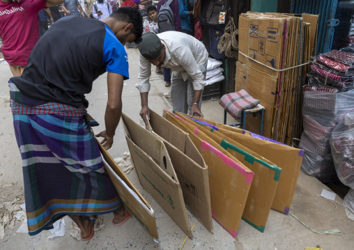 Bangladeshi men collecting cardboard boxes to recycle, Dhaka Division, Dhaka, Bangladesh