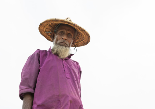 Old male worker with a bamboo hat at a brick factory, Sylhet Division, Bahubal, Bangladesh