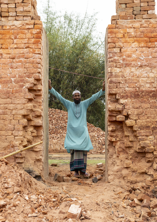 Onwer standing in the entrance of an oven of his brick factory, Sylhet Division, Bahubal, Bangladesh