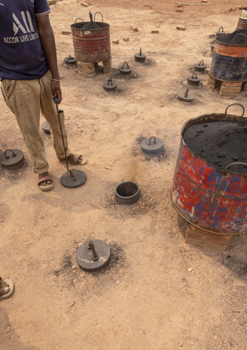 Worker on the roof of the giant oven at a brick factory, Sylhet Division, Bahubal, Bangladesh